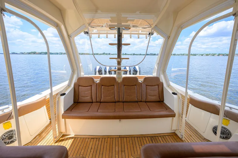 53 Scout Yacht Photos Pics Interior view of 2021 Scout 530 LXF boat with luxurious seating and scenic water backdrop.
