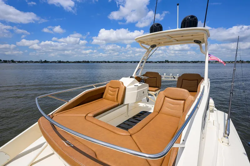 53 Scout Yacht Photos Pics 2021 Scout 530 LXF boat with luxurious seating on calm waters.