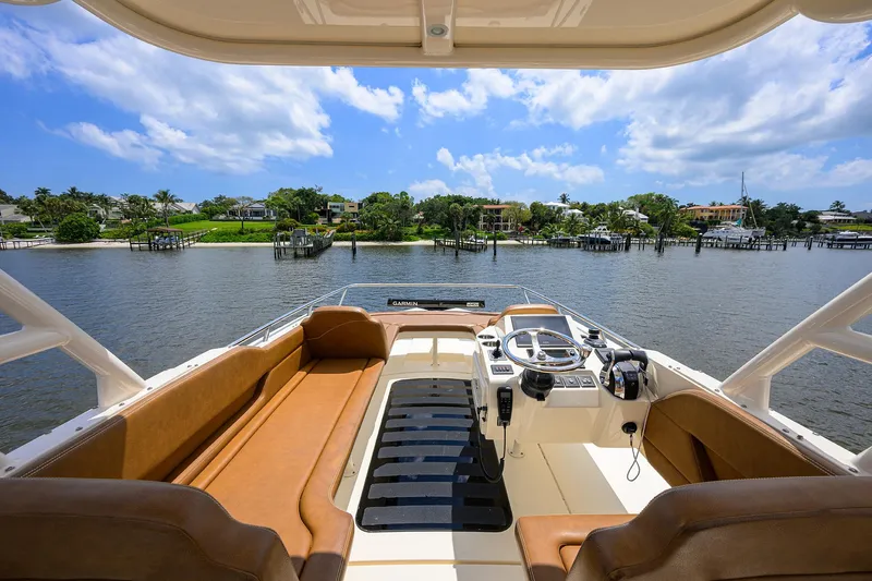 53 Scout Yacht Photos Pics 2021 Scout 530 LXF boat interior with luxurious seating and scenic waterfront view.