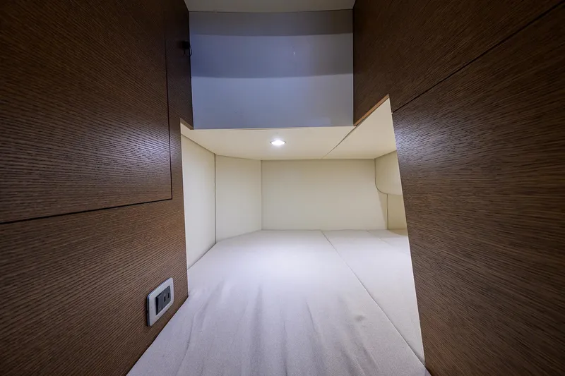 53 Scout Yacht Photos Pics 2021 Scout 530 LXF cabin interior with wood paneling and soft lighting.