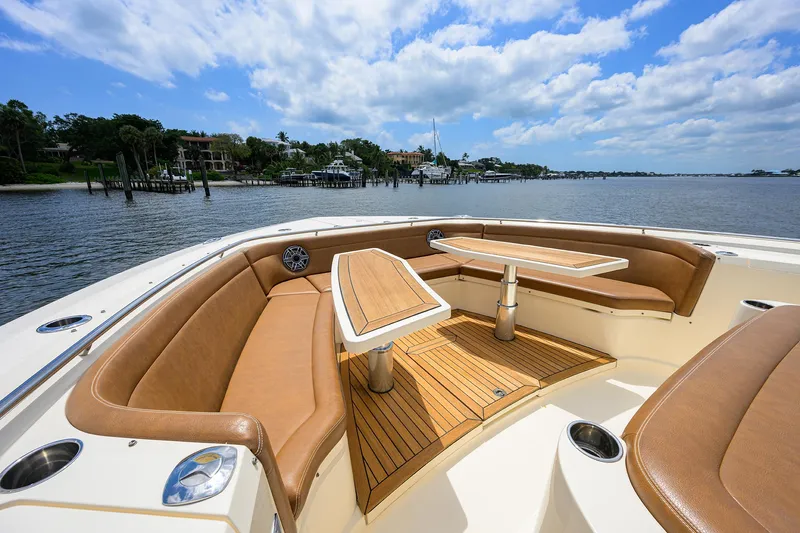 53 Scout Yacht Photos Pics Luxurious 2021 Scout 530 LXF boat interior with tan seating and wooden tables.