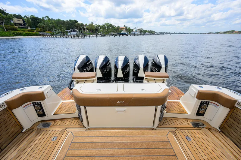 53 Scout Yacht Photos Pics 2021 Scout 530 LXF boat with five outboard engines on a wooden deck.