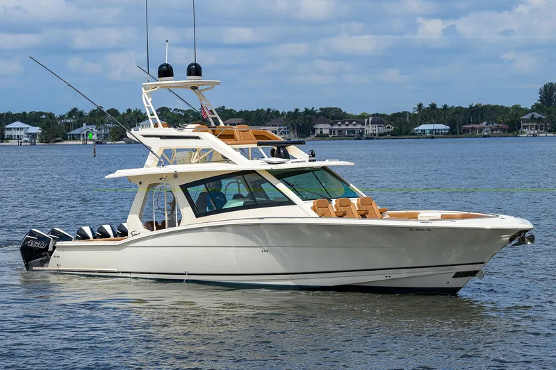 53 Scout Yacht Photos Pics 2021 Scout 530 LXF luxury boat cruising on a calm lake.