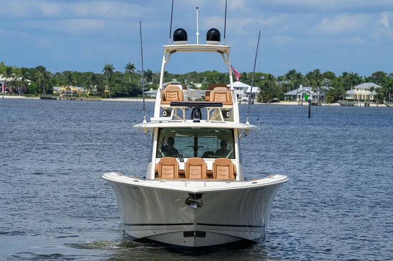 53 Scout Yacht Photos Pics 2021 Scout 530 LXF luxury boat on calm water, showcasing sleek design and spacious seating.