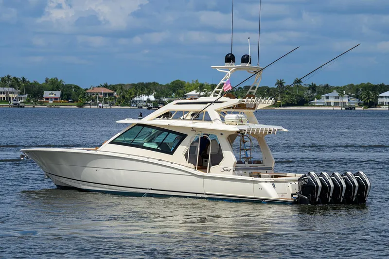 53 Scout Yacht Photos Pics 2021 Scout 530 LXF luxury boat on calm water with multiple outboard engines.