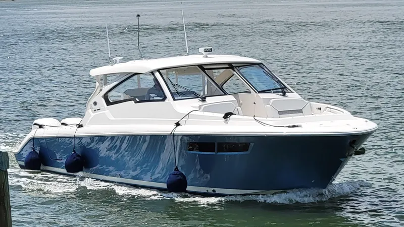  Yacht Photos Pics 2023 Pursuit DC 365 Dual Console boat cruising on water.