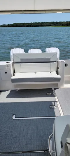  Yacht Photos Pics 2023 Pursuit DC 365 Dual Console boat with seating, on calm water.