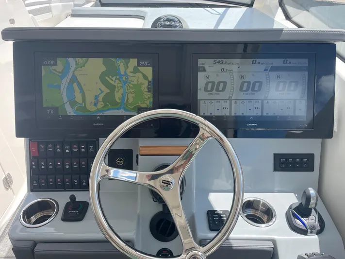  Yacht Photos Pics 2023 Pursuit DC 365 Dual Console dashboard with navigation screens and steering wheel.