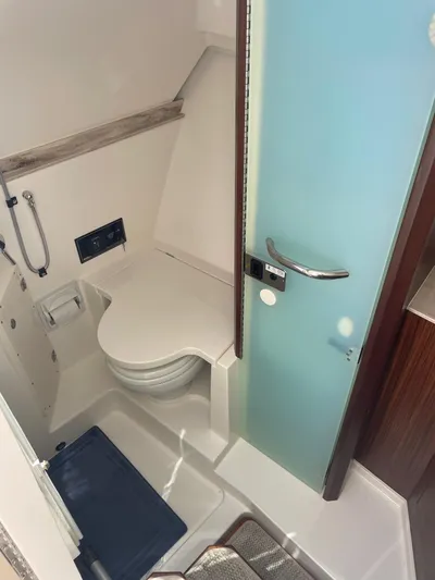  Yacht Photos Pics 2023 Pursuit DC 365 Dual Console boat bathroom with modern fixtures and sleek design.