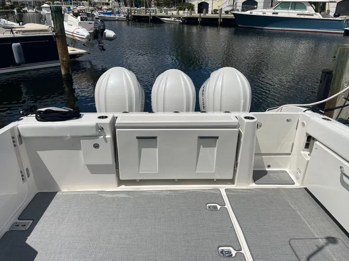  Yacht Photos Pics 2023 Pursuit DC 365 Dual Console boat with triple engines docked at marina.