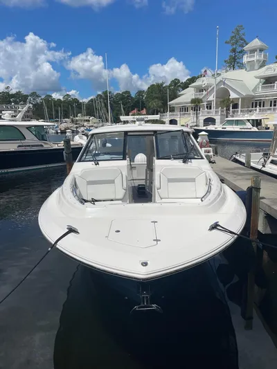  Yacht Photos Pics 2023 Pursuit DC 365 Dual Console boat docked at a marina under a blue sky.