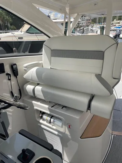 Yacht Photos Pics 2023 Pursuit DC 365 Dual Console boat interior with luxurious seating and modern controls.
