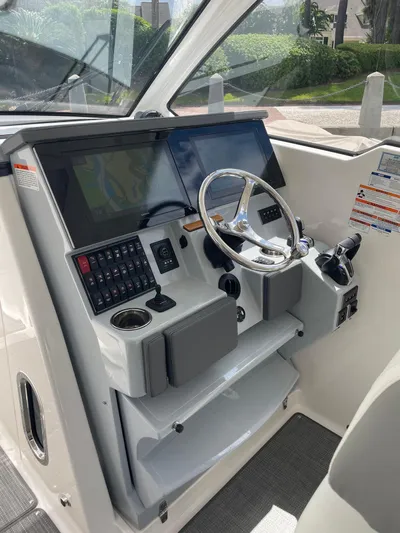 Yacht Photos Pics 2023 Pursuit DC 365 Dual Console helm with modern controls and steering wheel.