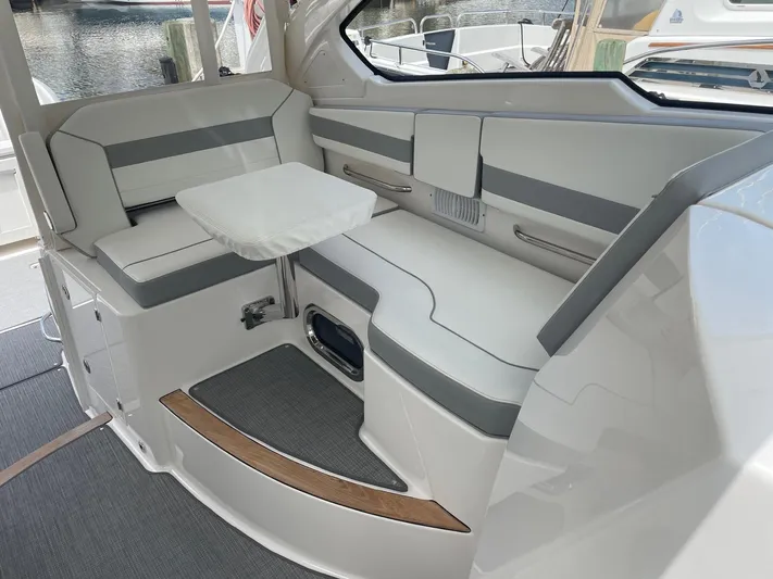  Yacht Photos Pics 2023 Pursuit DC 365 Dual Console interior with sleek seating and compact table.