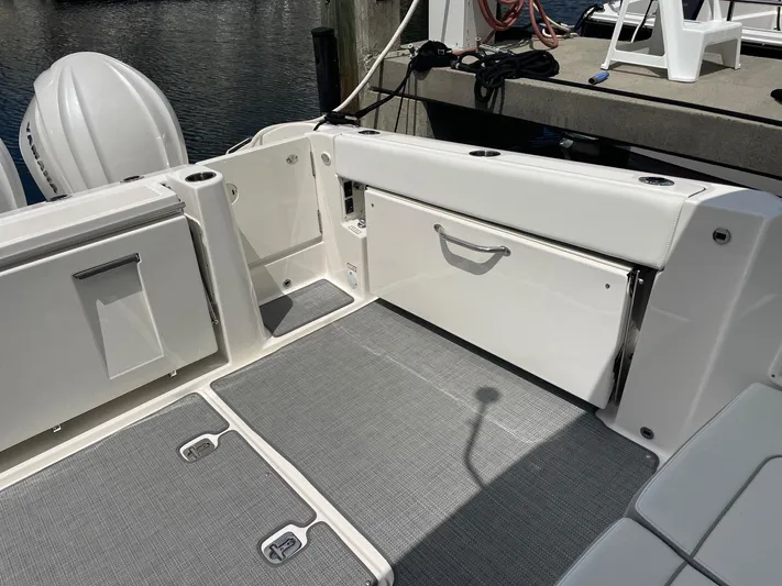  Yacht Photos Pics 2023 Pursuit DC 365 Dual Console boat interior with storage compartments and seating.