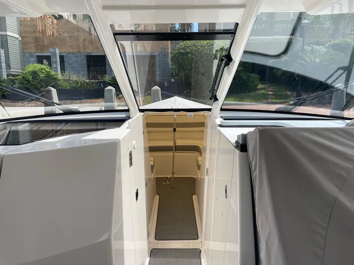  Yacht Photos Pics 2023 Pursuit DC 365 Dual Console interior with open cabin door, showcasing sleek design.