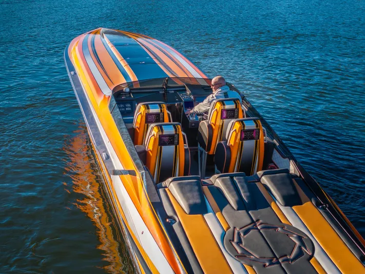  Yacht Photos Pics 2020 Fountain 47 Lightning speedboat with vibrant orange and yellow design on the water.
