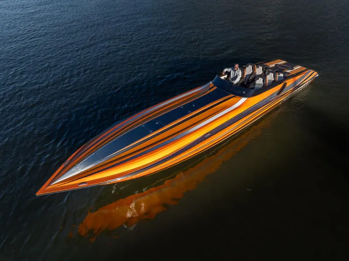  Yacht Photos Pics 2020 Fountain 47 Lightning speedboat with vibrant orange and black stripes on the water.
