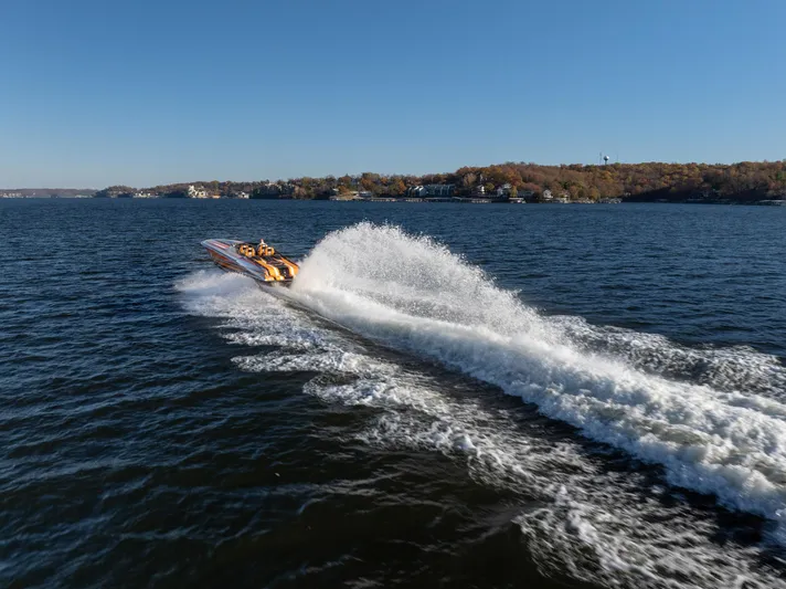  Yacht Photos Pics 2020 Fountain 47 Lightning speedboat creating a large wake on a sunny lake.