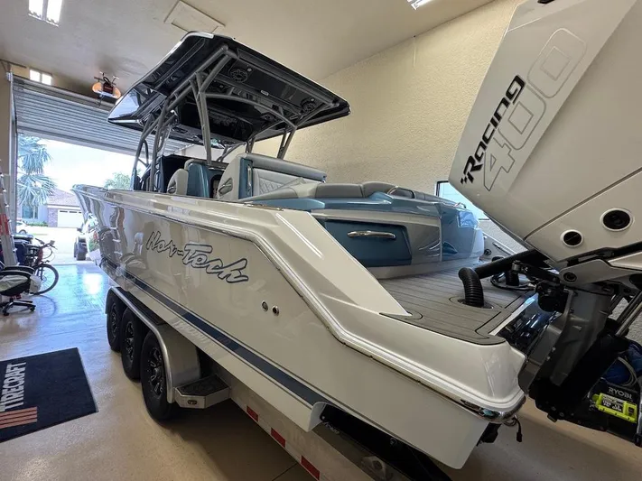  Yacht Photos Pics 2024 Nor-Tech 390 Sport Center Console boat with Racing 400 engine in a garage.