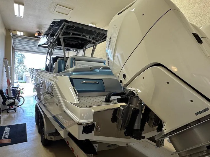  Yacht Photos Pics 2024 Nor-Tech 390 Sport Center Console in garage, showcasing powerful outboard engines.