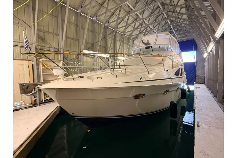 Bellissimo Yacht Photos Pics 2006 Silverton 38 Sport Bridge yacht docked in a covered marina.