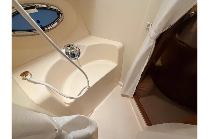 Bellissimo Yacht Photos Pics Bathroom interior of 2006 Silverton 38 Sport Bridge yacht with shower and porthole.