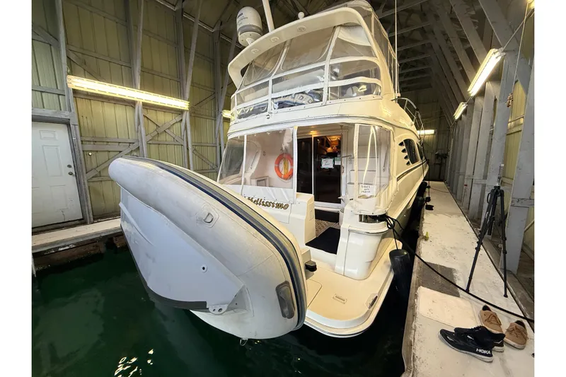 Bellissimo Yacht Photos Pics 2006 Silverton 38 Sport Bridge yacht docked in a covered marina.