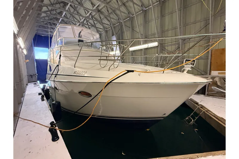 Bellissimo Yacht Photos Pics 2006 Silverton 38 Sport Bridge yacht docked in a covered marina.