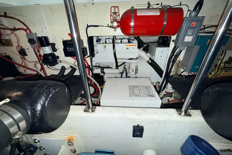 Bellissimo Yacht Photos Pics Engine room of a 2006 Silverton 38 Sport Bridge with fire extinguisher and electrical components.