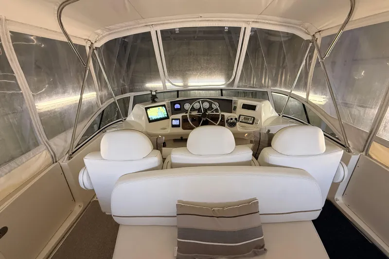 Bellissimo Yacht Photos Pics 2006 Silverton 38 Sport Bridge helm with white seating and navigation equipment.