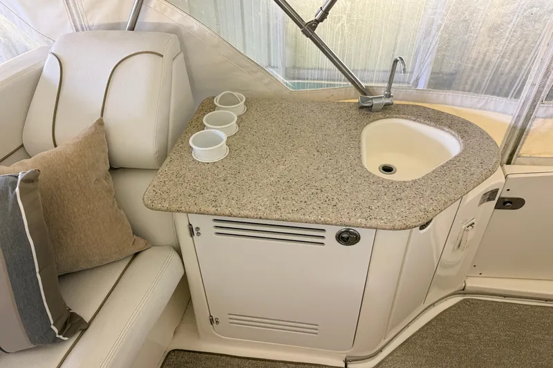 Bellissimo Yacht Photos Pics 2006 Silverton 38 Sport Bridge interior with sink, countertop, and seating area.