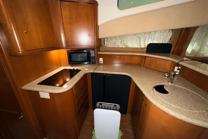 Bellissimo Yacht Photos Pics 2006 Silverton 38 Sport Bridge yacht kitchen with wood cabinetry and modern appliances.