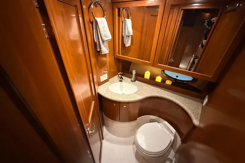 Bellissimo Yacht Photos Pics Luxurious 2006 Silverton 38 Sport Bridge yacht bathroom with wood cabinetry and modern fixtures.
