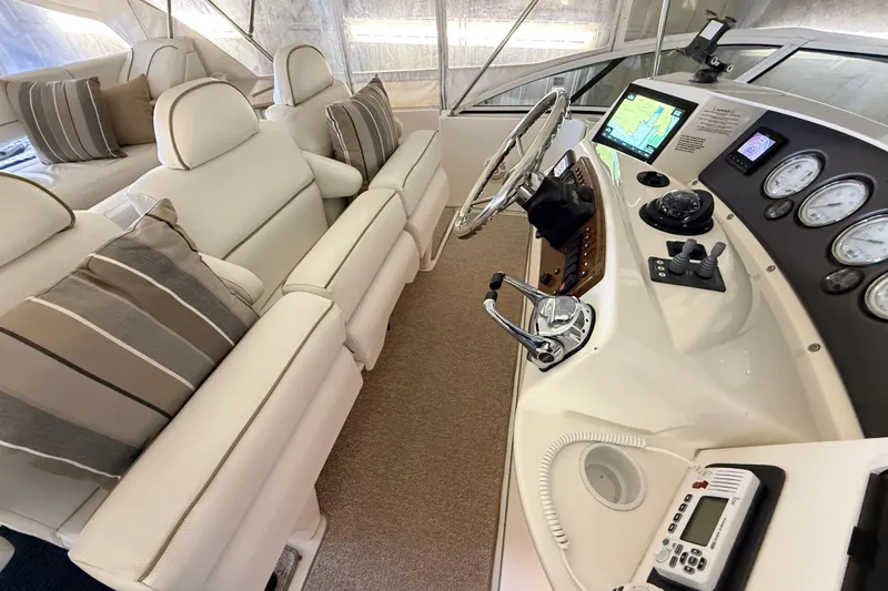 Bellissimo Yacht Photos Pics Interior of 2006 Silverton 38 Sport Bridge with plush seating and modern helm controls.
