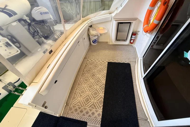 Bellissimo Yacht Photos Pics 2006 Silverton 38 Sport Bridge yacht interior with Yamaha engine, safety equipment, and carpeted flooring.