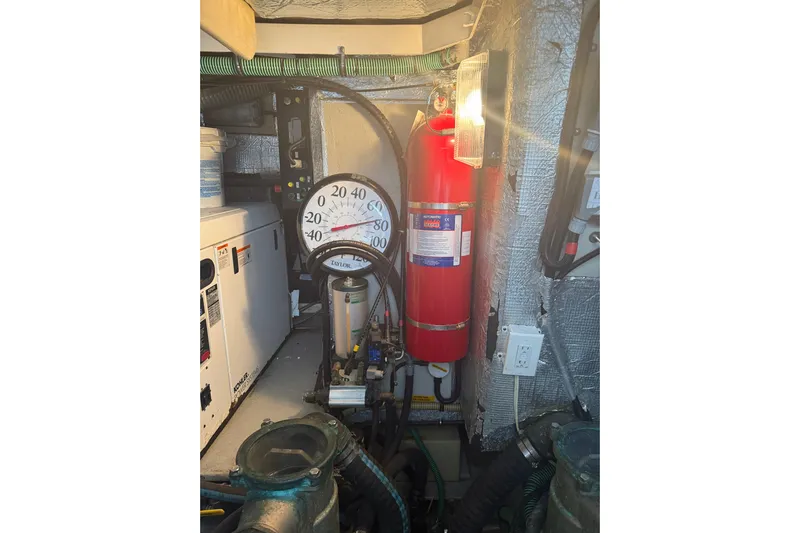Seaya II Yacht Photos Pics Engine room of 2008 Sunseeker Manhattan 50 yacht with fire extinguisher and temperature gauge.