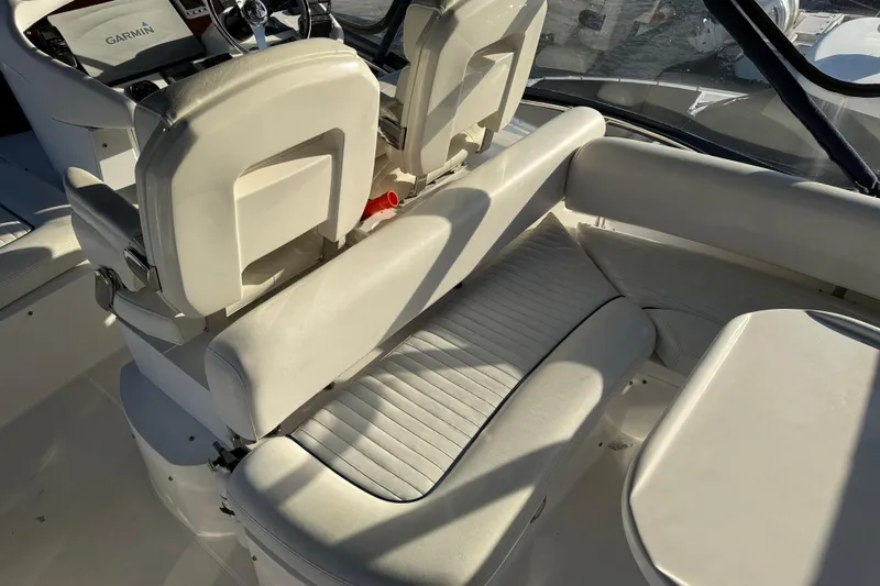 Seaya II Yacht Photos Pics Interior of 2008 Sunseeker Manhattan 50 yacht with white seating and Garmin navigation.