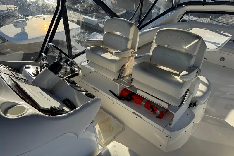 Seaya II Yacht Photos Pics Interior of 2008 Sunseeker Manhattan 50 yacht with helm and white seating.