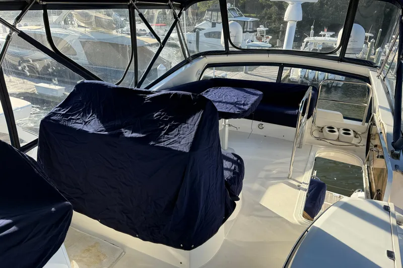 Seaya II Yacht Photos Pics 2008 Sunseeker Manhattan 50 yacht interior with covered seating and helm station.