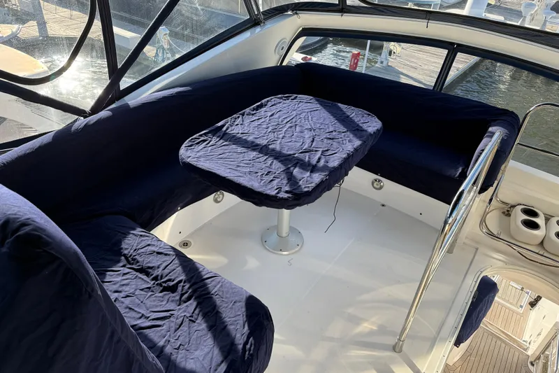 Seaya II Yacht Photos Pics 2008 Sunseeker Manhattan 50 yacht interior with blue-covered seating and table.