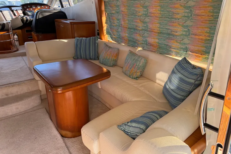 Seaya II Yacht Photos Pics Luxurious interior of 2008 Sunseeker Manhattan 50 yacht with plush seating and wooden table.