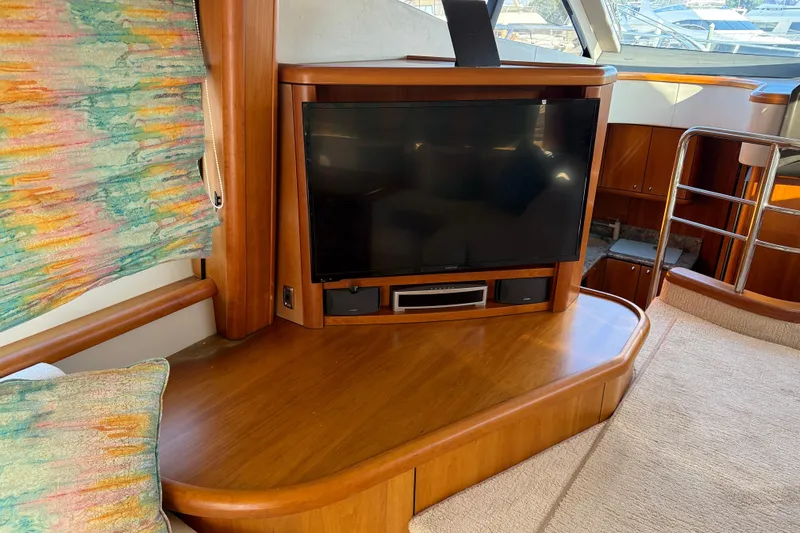 Seaya II Yacht Photos Pics Luxurious interior of 2008 Sunseeker Manhattan 50 yacht with TV and wooden furnishings.