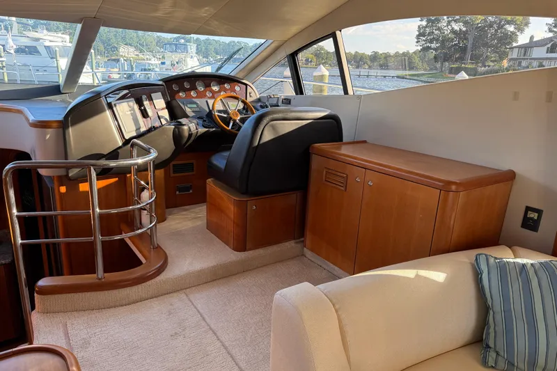 Seaya II Yacht Photos Pics Interior of 2008 Sunseeker Manhattan 50 yacht, featuring helm station and wooden cabinetry.