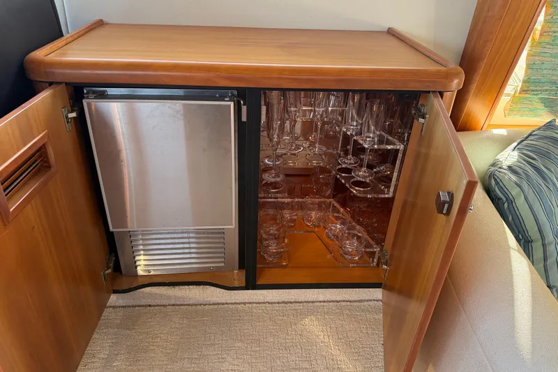 Seaya II Yacht Photos Pics Luxury yacht interior with glassware cabinet and mini fridge, Sunseeker Manhattan 50, 2008 model.