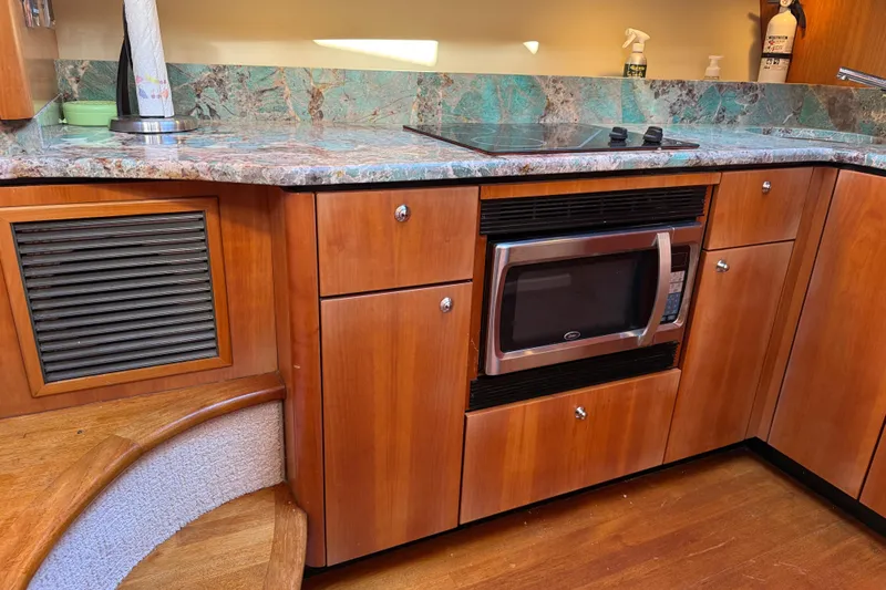 Seaya II Yacht Photos Pics Luxurious kitchen area in a 2008 Sunseeker Manhattan 50 yacht with wood cabinetry.