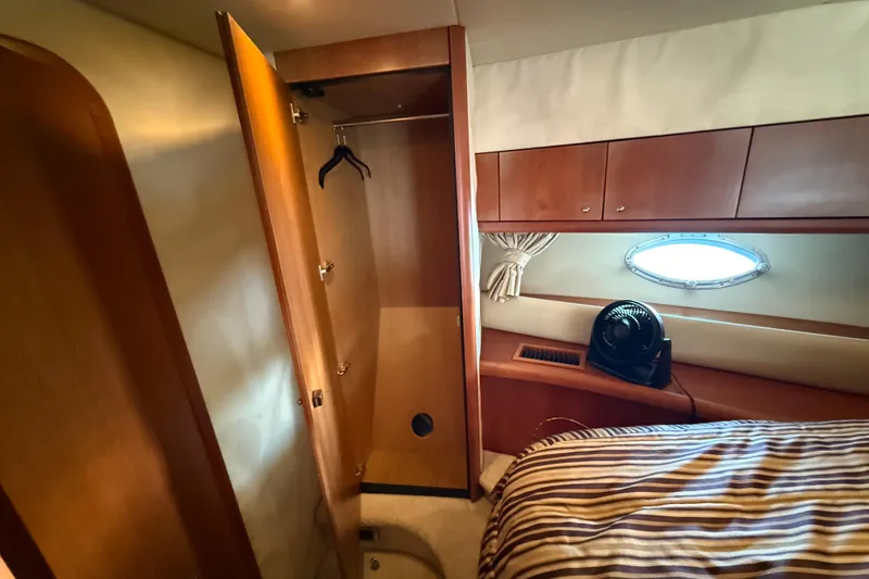 Seaya II Yacht Photos Pics Interior of 2008 Sunseeker Manhattan 50 yacht with open closet and porthole window.