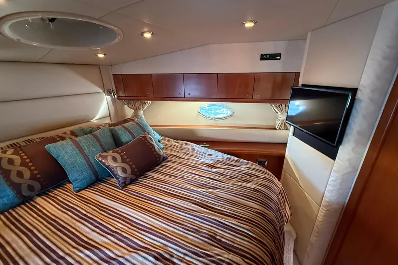 Seaya II Yacht Photos Pics Luxurious cabin interior of 2008 Sunseeker Manhattan 50 yacht with cozy bedding and TV.