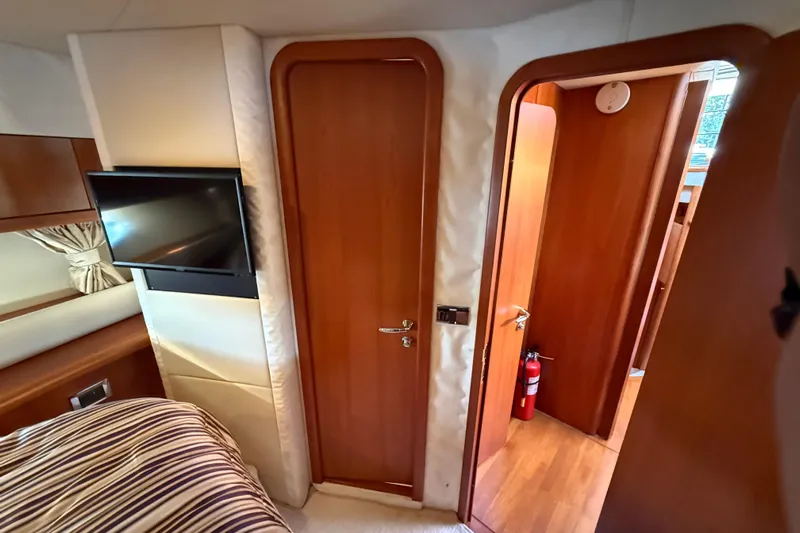 Seaya II Yacht Photos Pics Interior of 2008 Sunseeker Manhattan 50 yacht with wood doors and mounted TV.