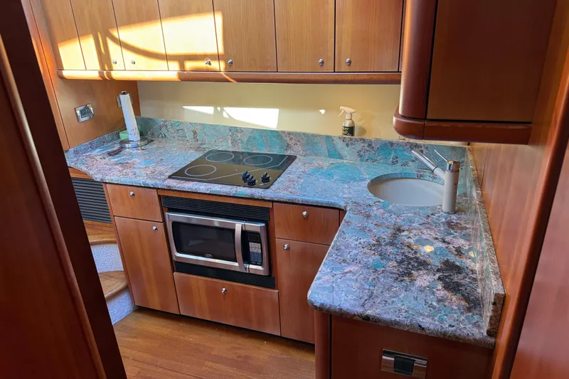 Seaya II Yacht Photos Pics Luxurious 2008 Sunseeker Manhattan 50 yacht kitchen with granite countertops and modern appliances.